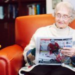 resident reading a newspaper