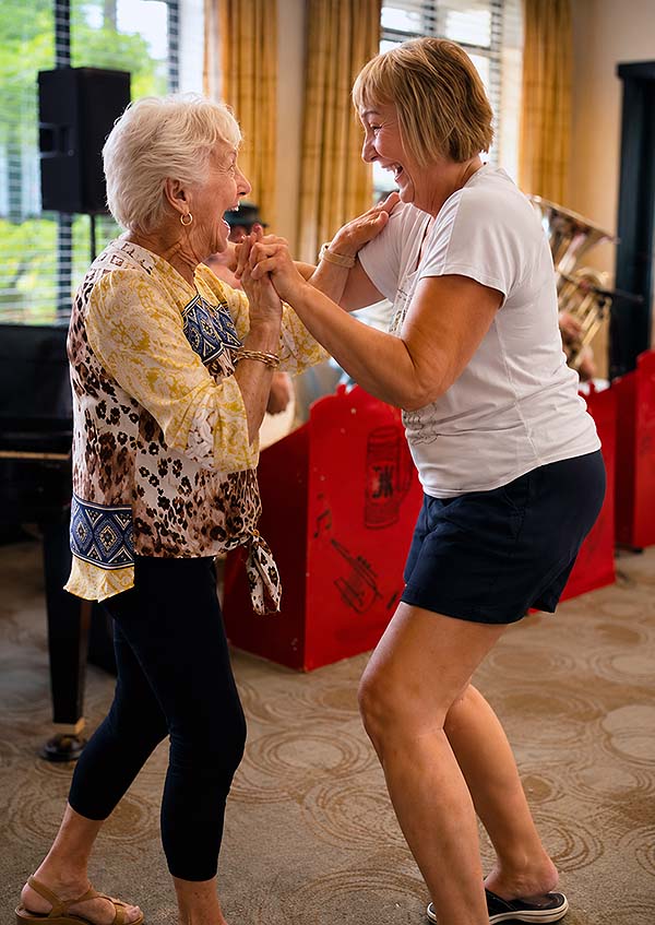 Two women dancing at Cordia Senior Residences at Westmont